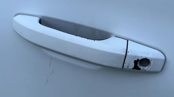 A chipped and worn Chevy Suburban door handle